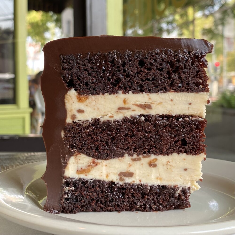 A slice of Butterfinger Chocolate cake showing the cake layers.