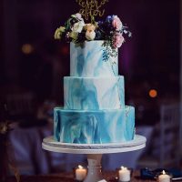Three-tiered blue marble pattern cake.
