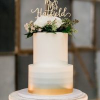 Two-tier ombre cake with flower placement.