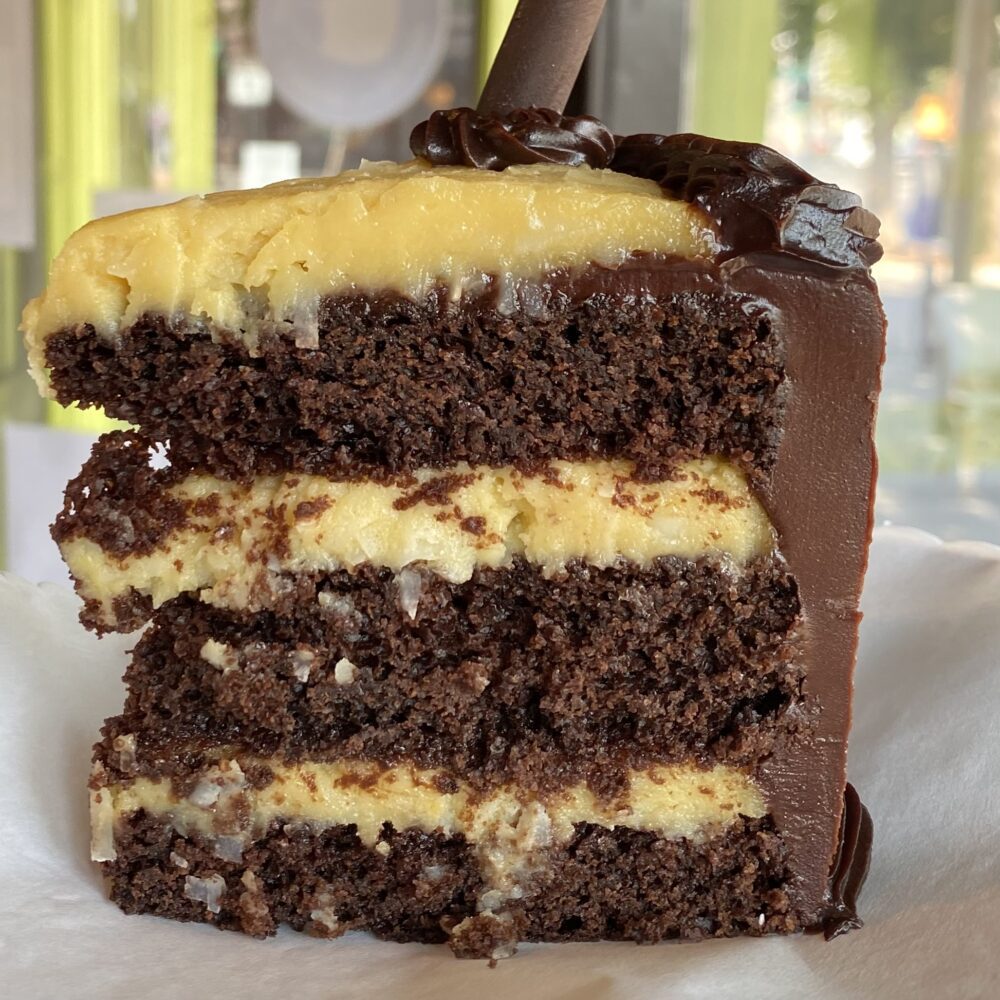 A slice of German Chocolate cake showing the cake layers.