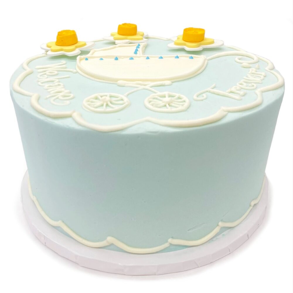 Baby Carriage decoration on a round cake frosted in blue buttercream.