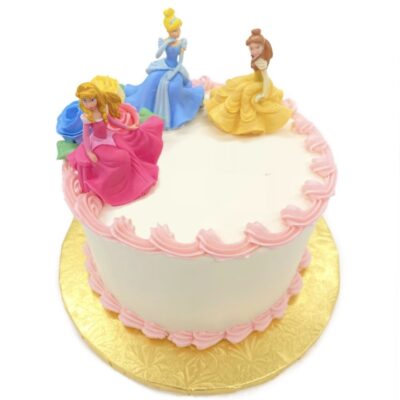 Side view of Disney Princess decoration on round cake frosted in white buttercream frosting.