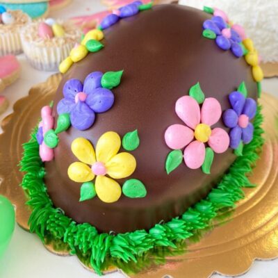 Egg-shaped cake decorated with buttercream.
