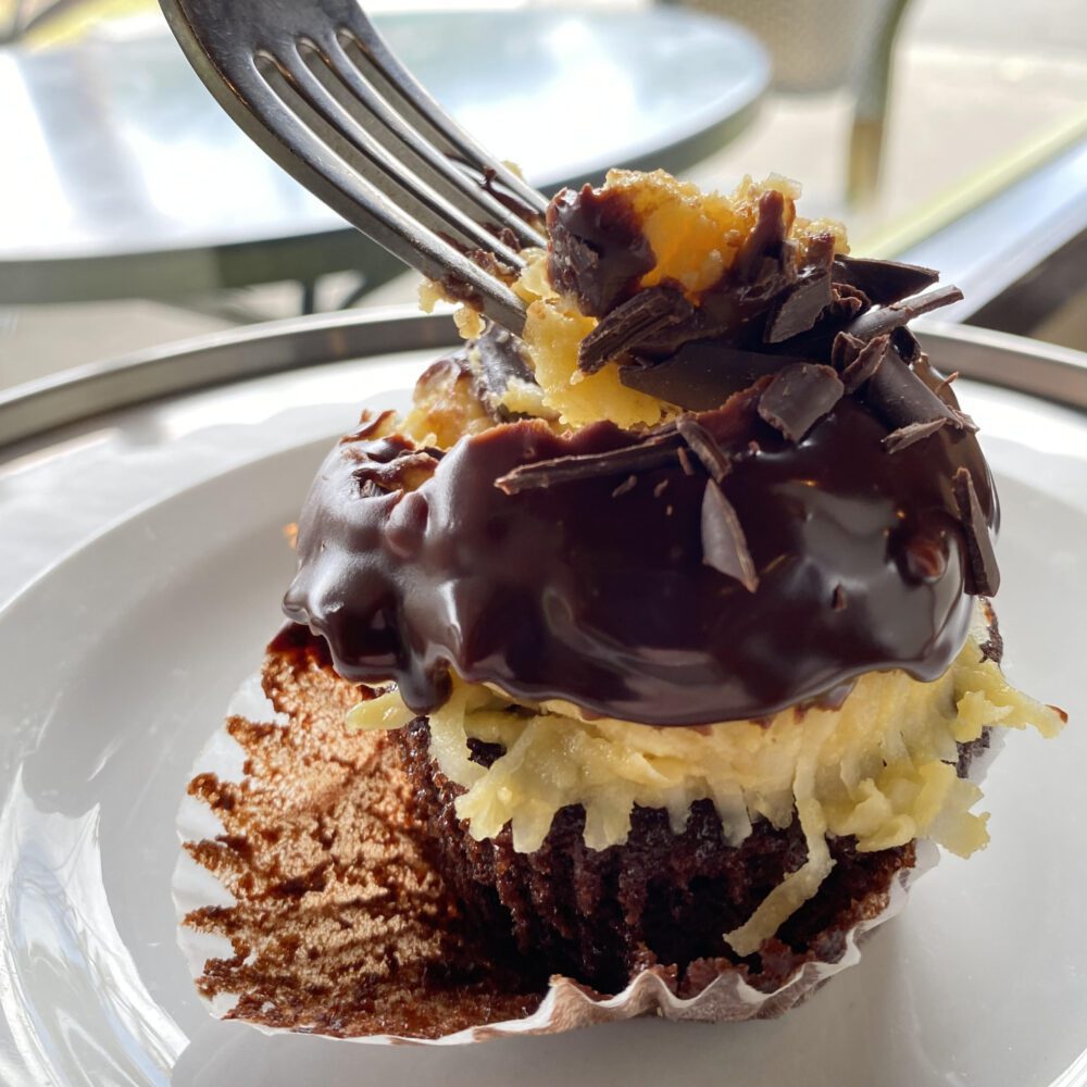 Detail of German Chocolate cupcake on plate with fork.