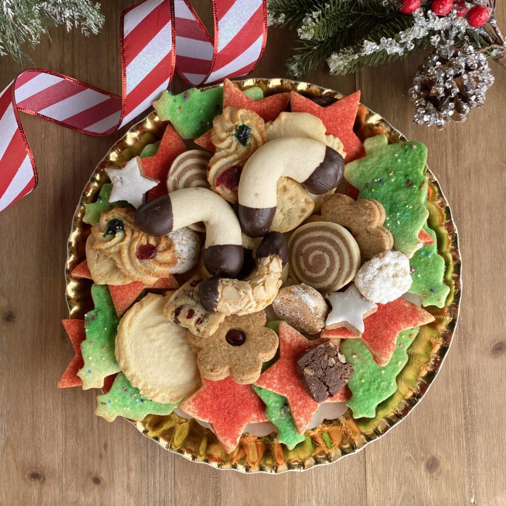 Old fashion cookie assortment on a round gold platter on a table.