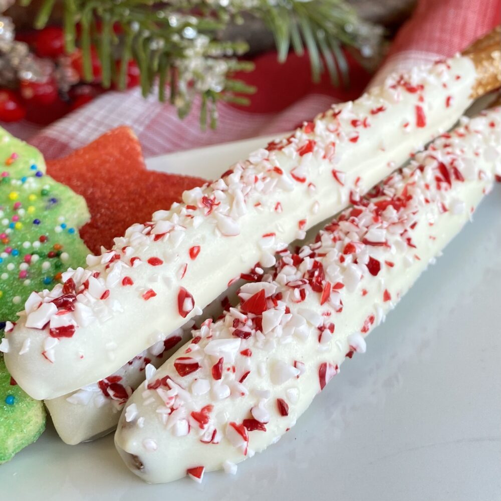 Detail of peppermint pretzel rods on a plate.