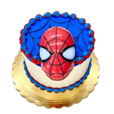 Side view of Spider-Man decoration on round cake in white buttercream.