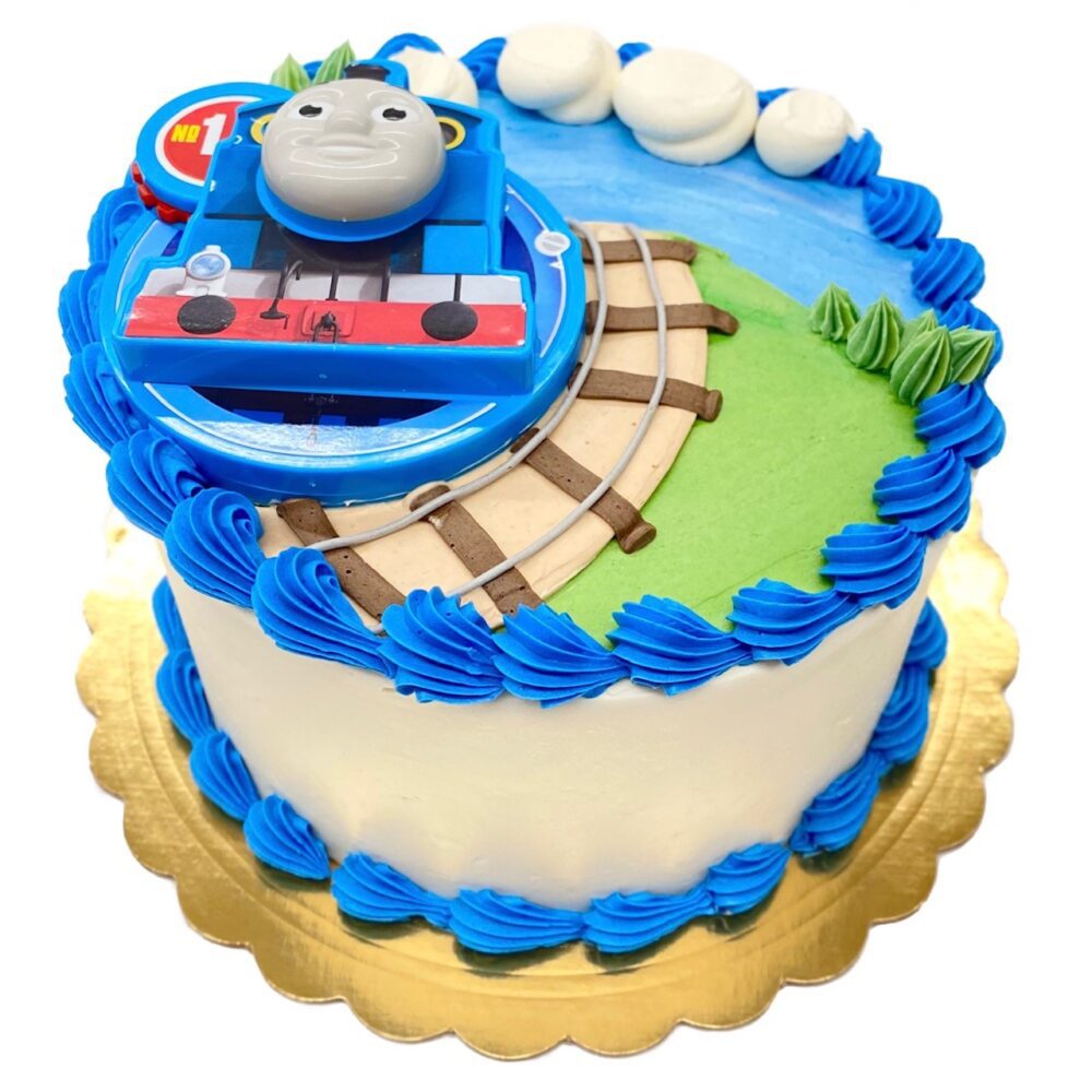 Thomas the Train decoration on a round cake frosted in white buttercream.