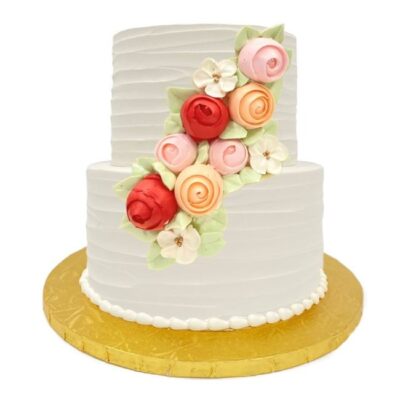 Example of two-tiered rustic style cake in white buttercream with roses cascade decoration.