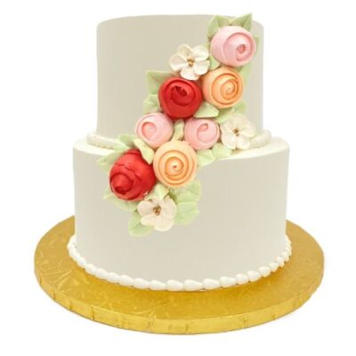Example of two-tiered smooth style cake in white buttercream with roses cascade decoration.