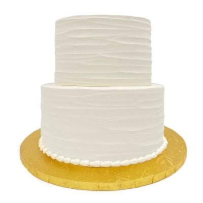 Example of two-tiered rustic style cake in white buttercream.