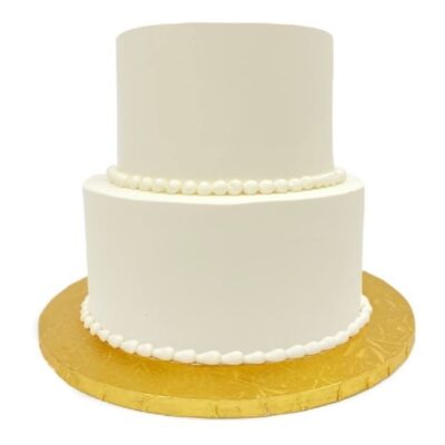 Example of two-tiered smooth style cake in white buttercream.